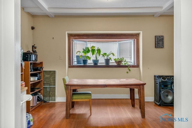 office area featuring hardwood / wood-style flooring and beam ceiling