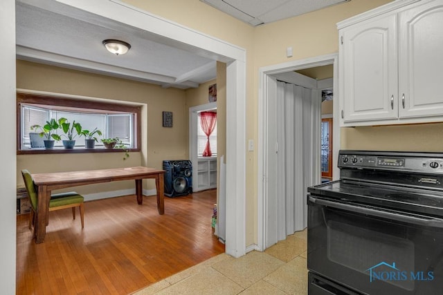 kitchen with white cabinetry and black electric range oven