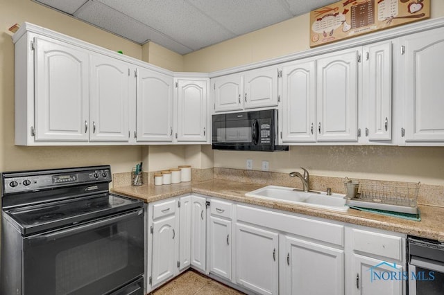 kitchen with sink, white cabinets, and black appliances