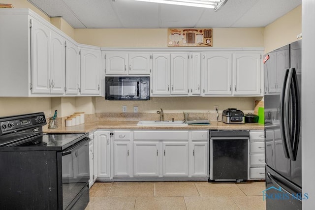 kitchen featuring white cabinetry, sink, black appliances, and a drop ceiling