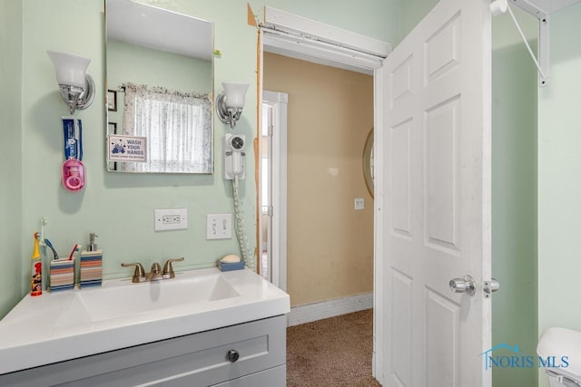 bathroom with vanity and toilet