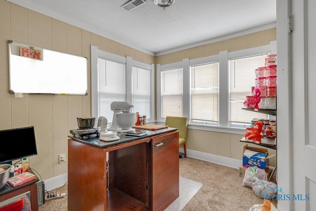 carpeted office featuring crown molding