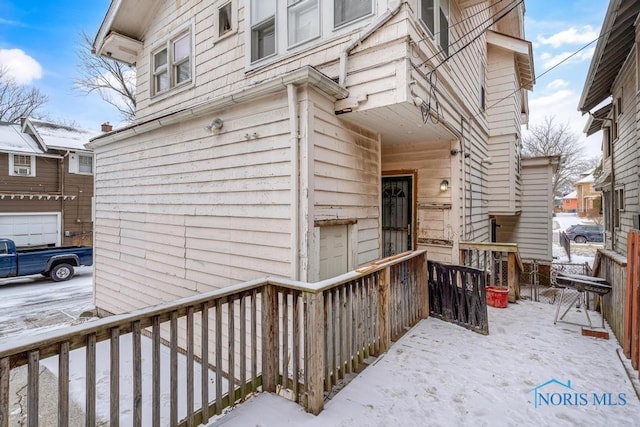 view of snow covered property entrance