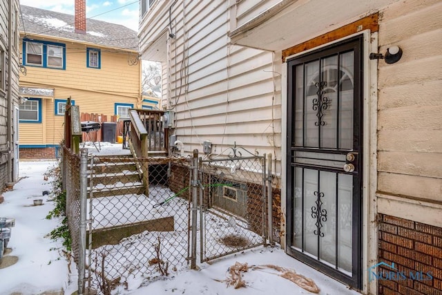 view of snow covered property entrance