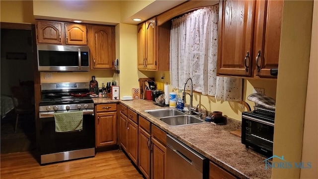 kitchen featuring sink, stainless steel appliances, and light wood-type flooring