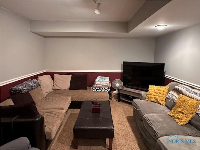 living room featuring rail lighting and carpet