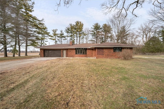 single story home featuring a garage and a front lawn