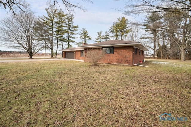 exterior space featuring a garage and a yard