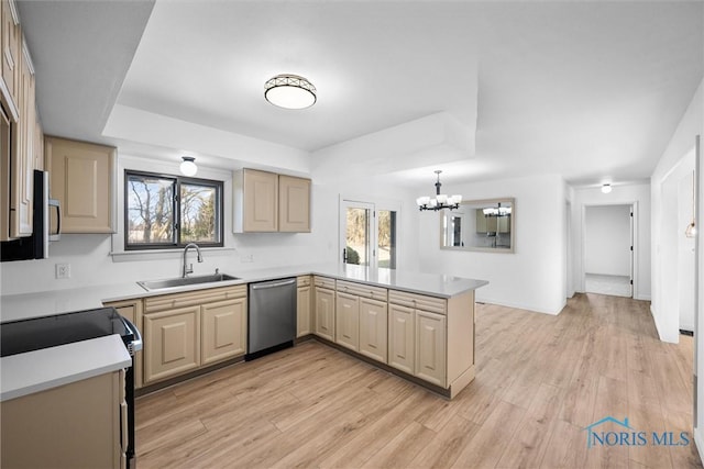 kitchen featuring sink, plenty of natural light, kitchen peninsula, and appliances with stainless steel finishes