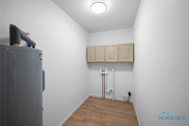 washroom featuring cabinets, washer hookup, water heater, and light wood-type flooring