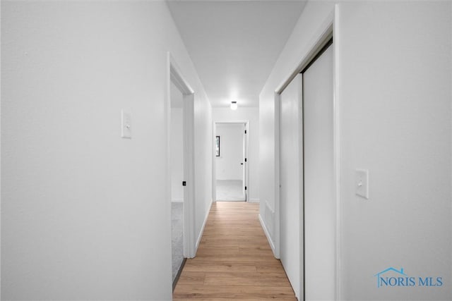 hallway featuring light wood-type flooring