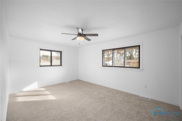 spare room with ceiling fan and carpet flooring