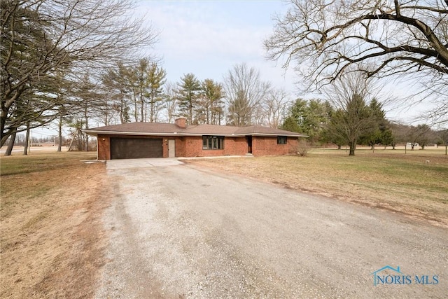 view of front of house with a garage and a front lawn