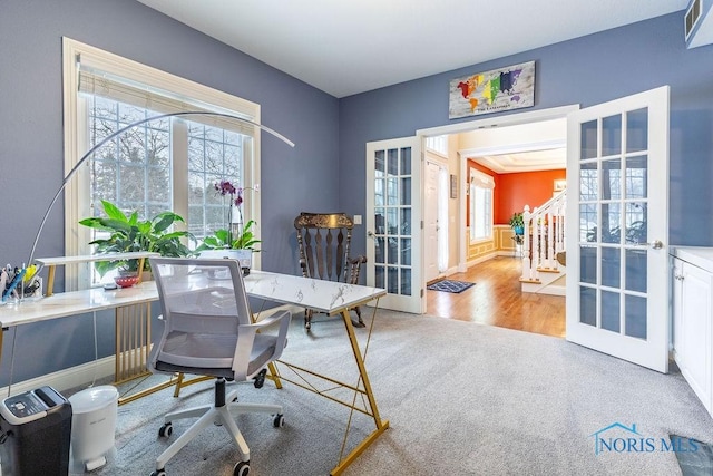 office with light carpet and french doors