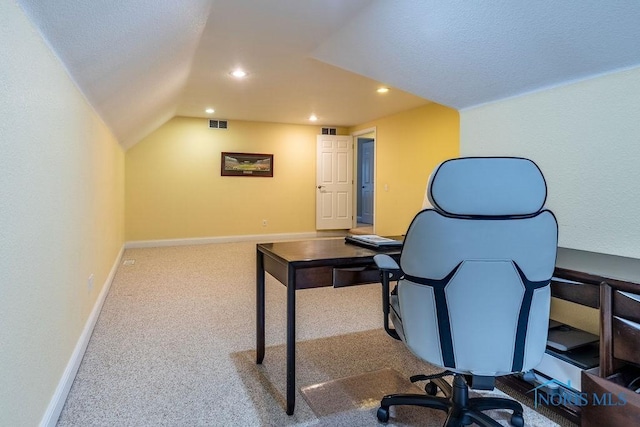 carpeted home office featuring lofted ceiling