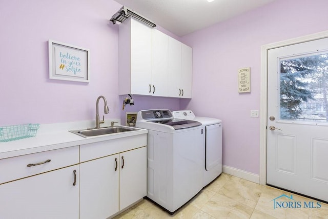 washroom featuring cabinets, separate washer and dryer, sink, and light tile patterned floors