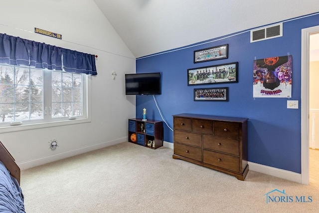 bedroom with vaulted ceiling and light carpet