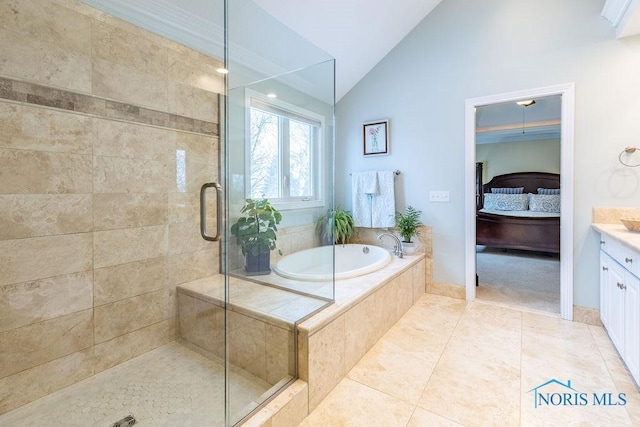 bathroom with tile patterned flooring, vanity, lofted ceiling, and separate shower and tub