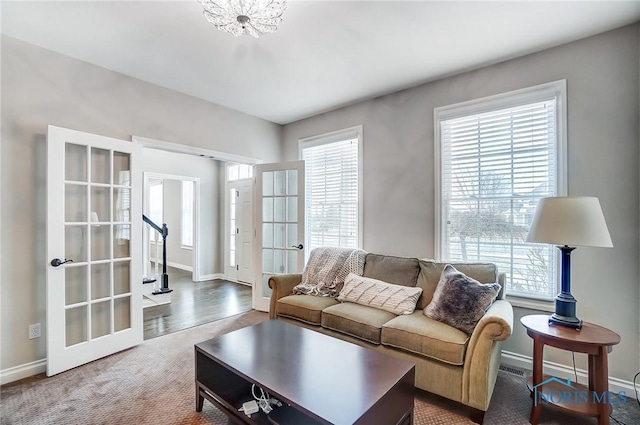 living room with plenty of natural light, carpet, and french doors