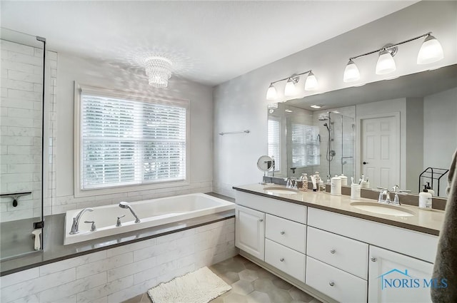 bathroom featuring vanity, tile patterned floors, and shower with separate bathtub