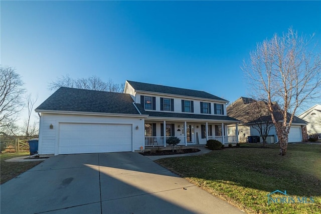 view of front of home with a porch, a garage, and a front lawn