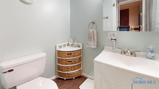 bathroom with vanity, hardwood / wood-style floors, and toilet