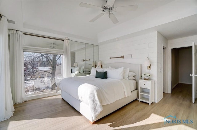 bedroom featuring light hardwood / wood-style flooring and ceiling fan