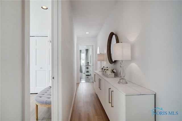 hallway with light hardwood / wood-style floors