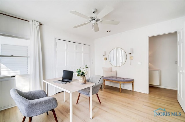 office space with ceiling fan and light hardwood / wood-style flooring