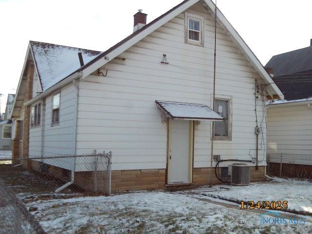 snow covered property featuring central air condition unit