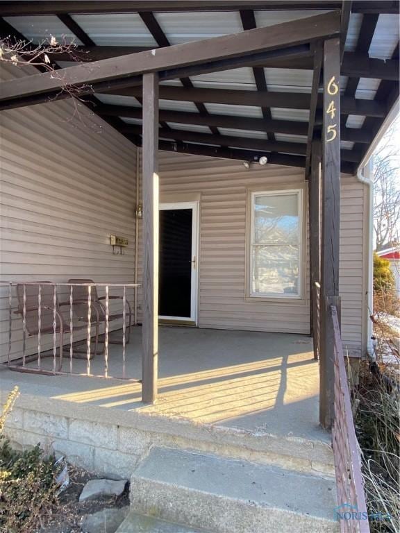 entrance to property featuring a patio