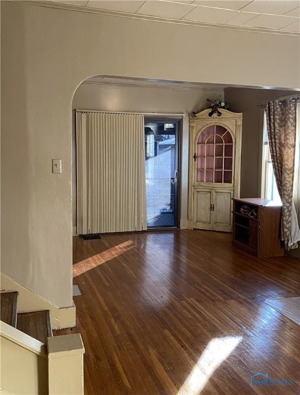 unfurnished living room featuring dark hardwood / wood-style floors