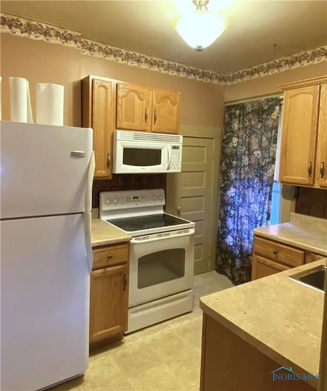 kitchen with sink and white appliances