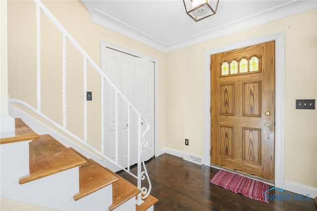 entrance foyer featuring crown molding and dark hardwood / wood-style flooring