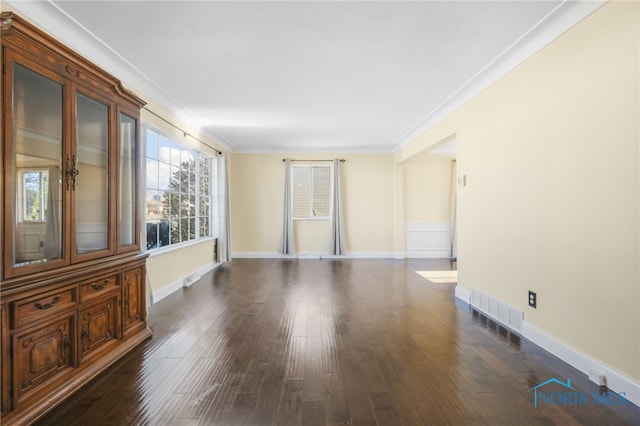 unfurnished room with ornamental molding and dark hardwood / wood-style floors