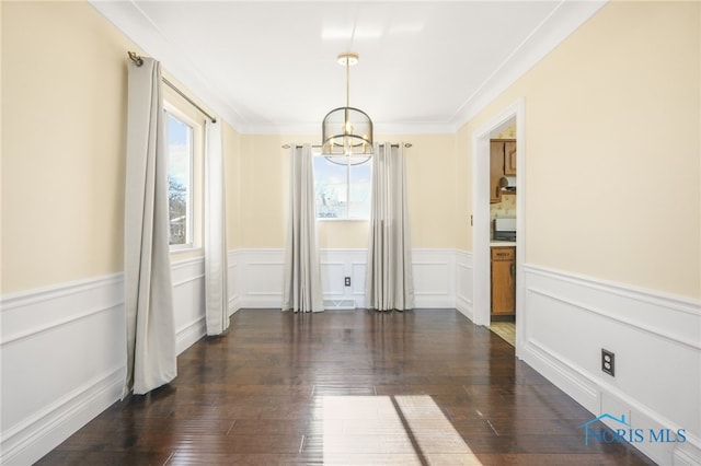 unfurnished dining area with crown molding, a chandelier, and dark hardwood / wood-style flooring