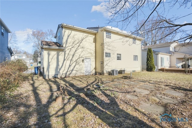 rear view of house with cooling unit