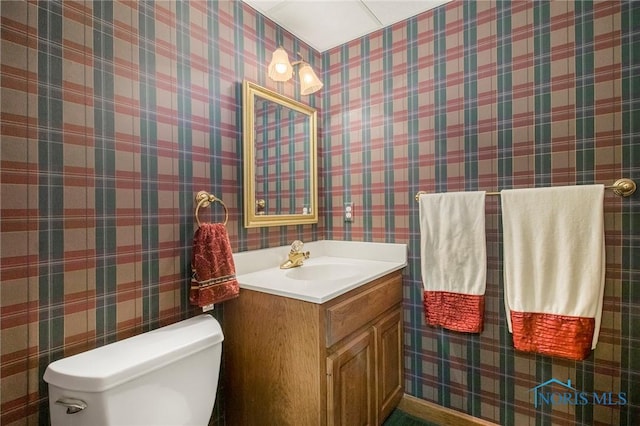 bathroom featuring vanity and toilet