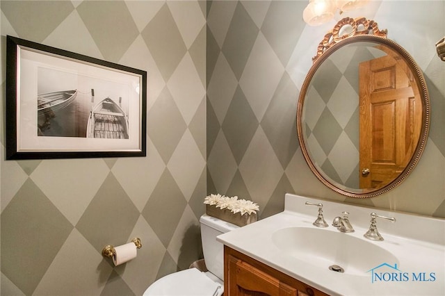 bathroom featuring vanity and toilet