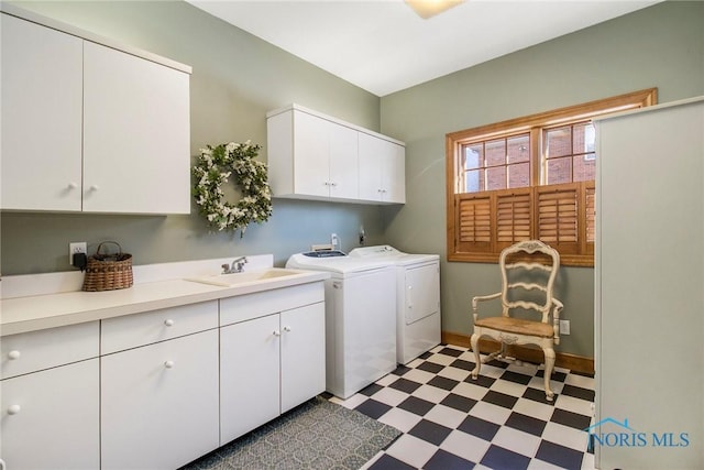 laundry room with cabinets, sink, and washer and clothes dryer