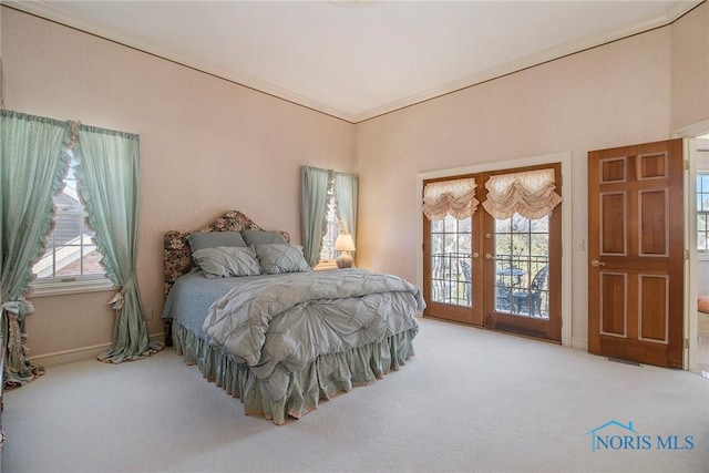 bedroom with french doors, ornamental molding, access to exterior, and carpet floors