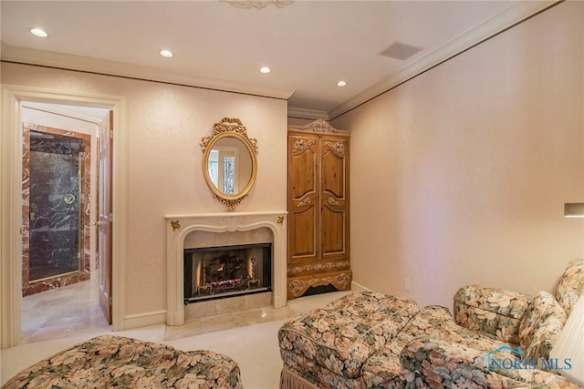 living area with ornamental molding and a premium fireplace