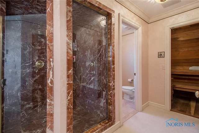 bathroom featuring ornamental molding and toilet