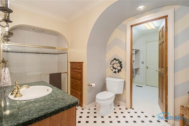 bathroom featuring vanity, crown molding, a shower with door, and toilet