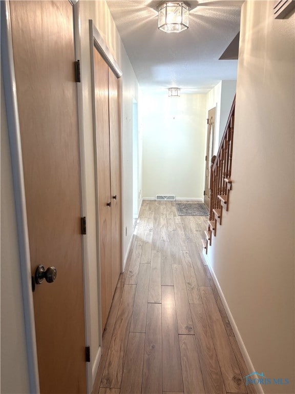 hall with light hardwood / wood-style flooring