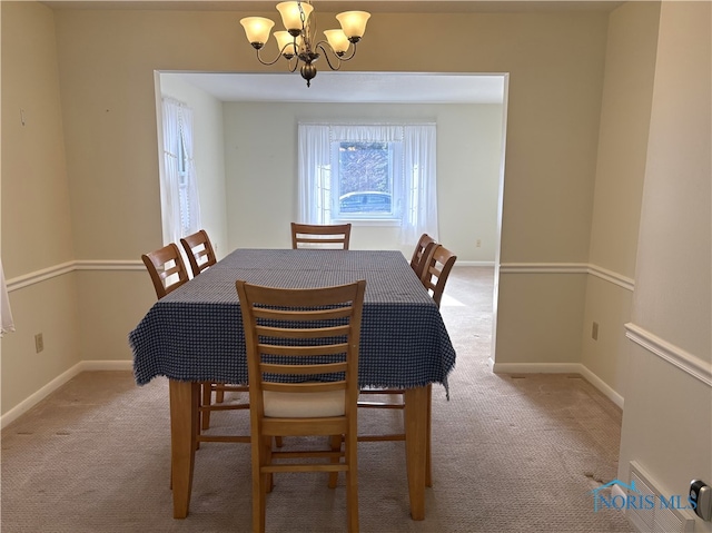 dining room featuring an inviting chandelier and light colored carpet