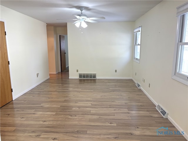 empty room featuring wood-type flooring and ceiling fan