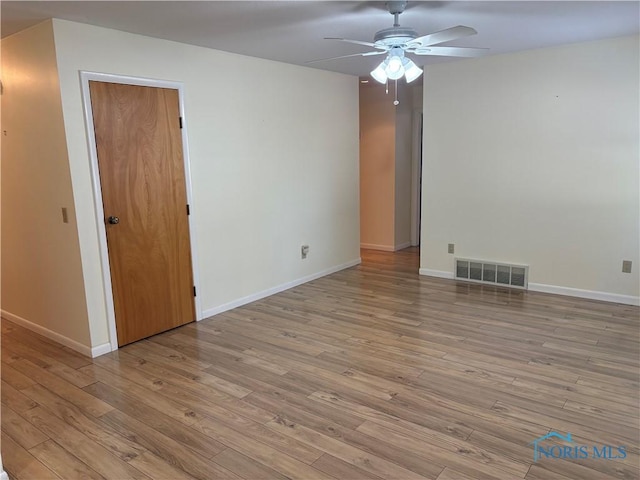 spare room featuring ceiling fan and light hardwood / wood-style flooring