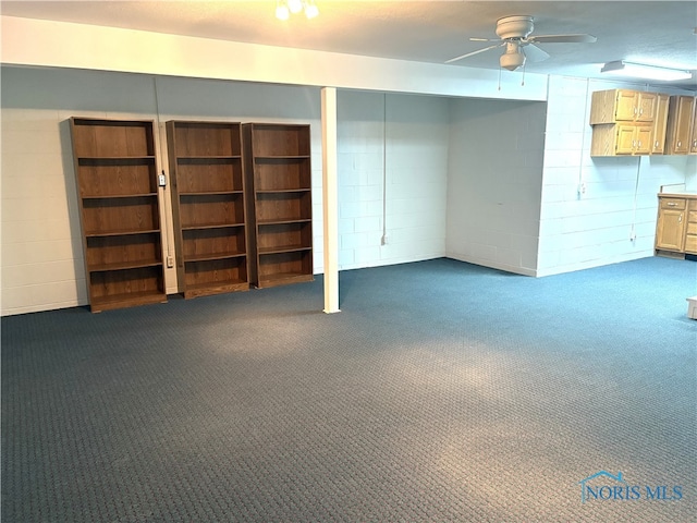 basement with dark carpet and ceiling fan