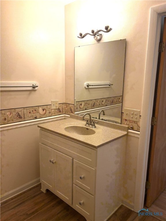 bathroom with vanity and hardwood / wood-style floors